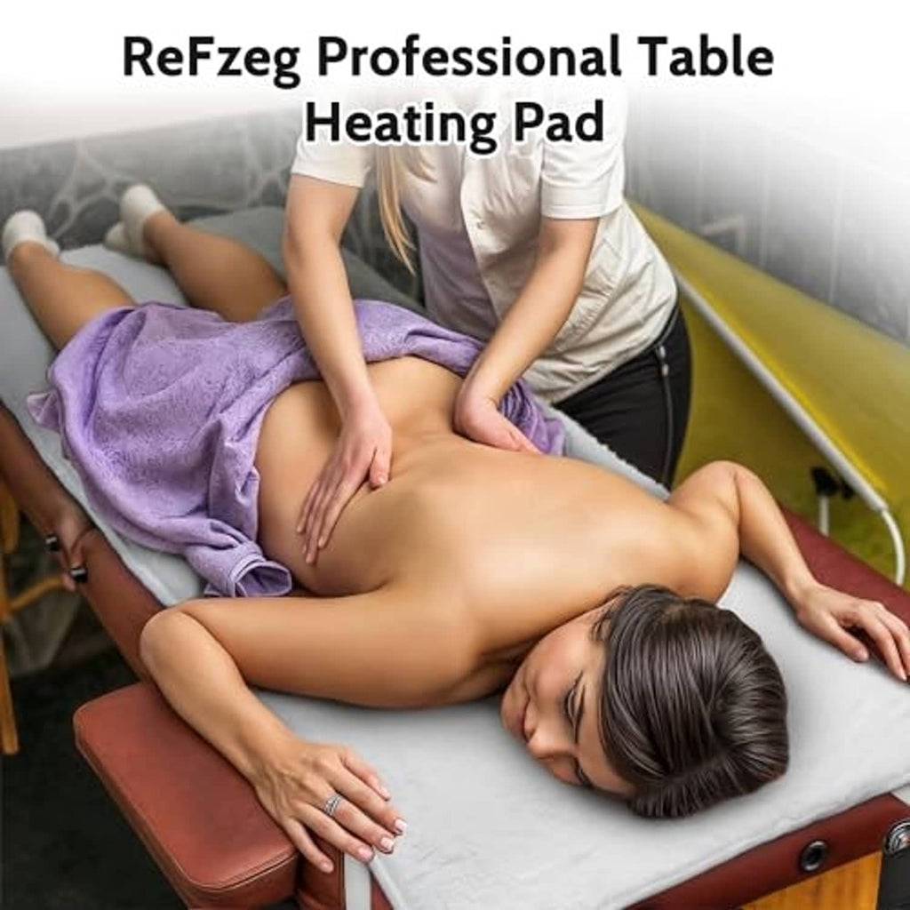 Massage table heating pad under client on a treatment bed with purple towel