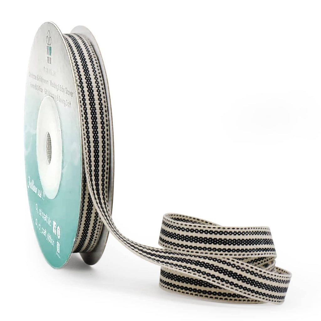 Ivory and black striped ribbon on a spool with thin woven texture