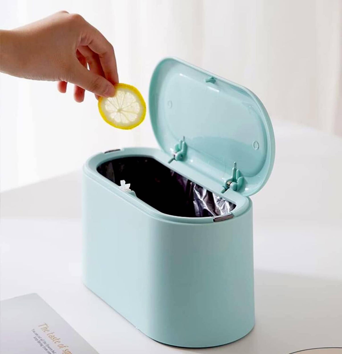 Light blue mini trash can with open lid and inner hooks, small waste inside