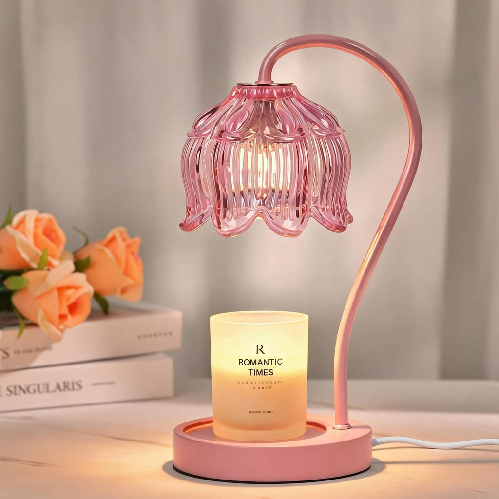 Pink flower-shaped candle warmer lamp with glowing jar candle on round base
