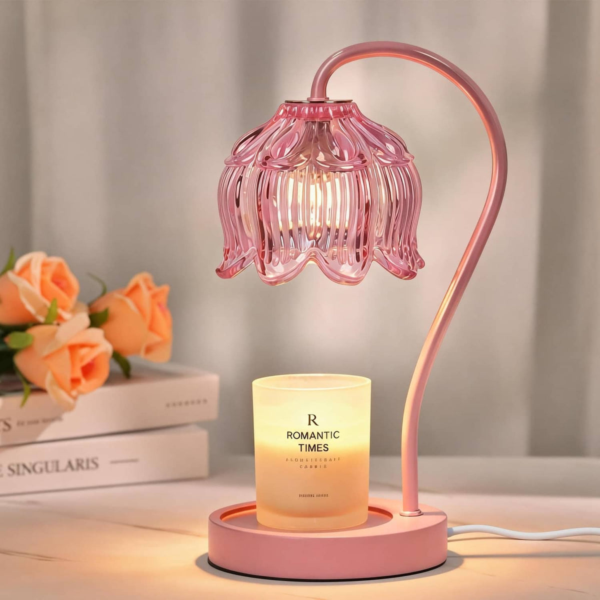 Pink flower-shaped candle warmer lamp with glowing jar candle on round base