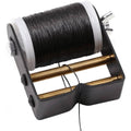Black archery bowstring serving thread on spool with white mounting flanges