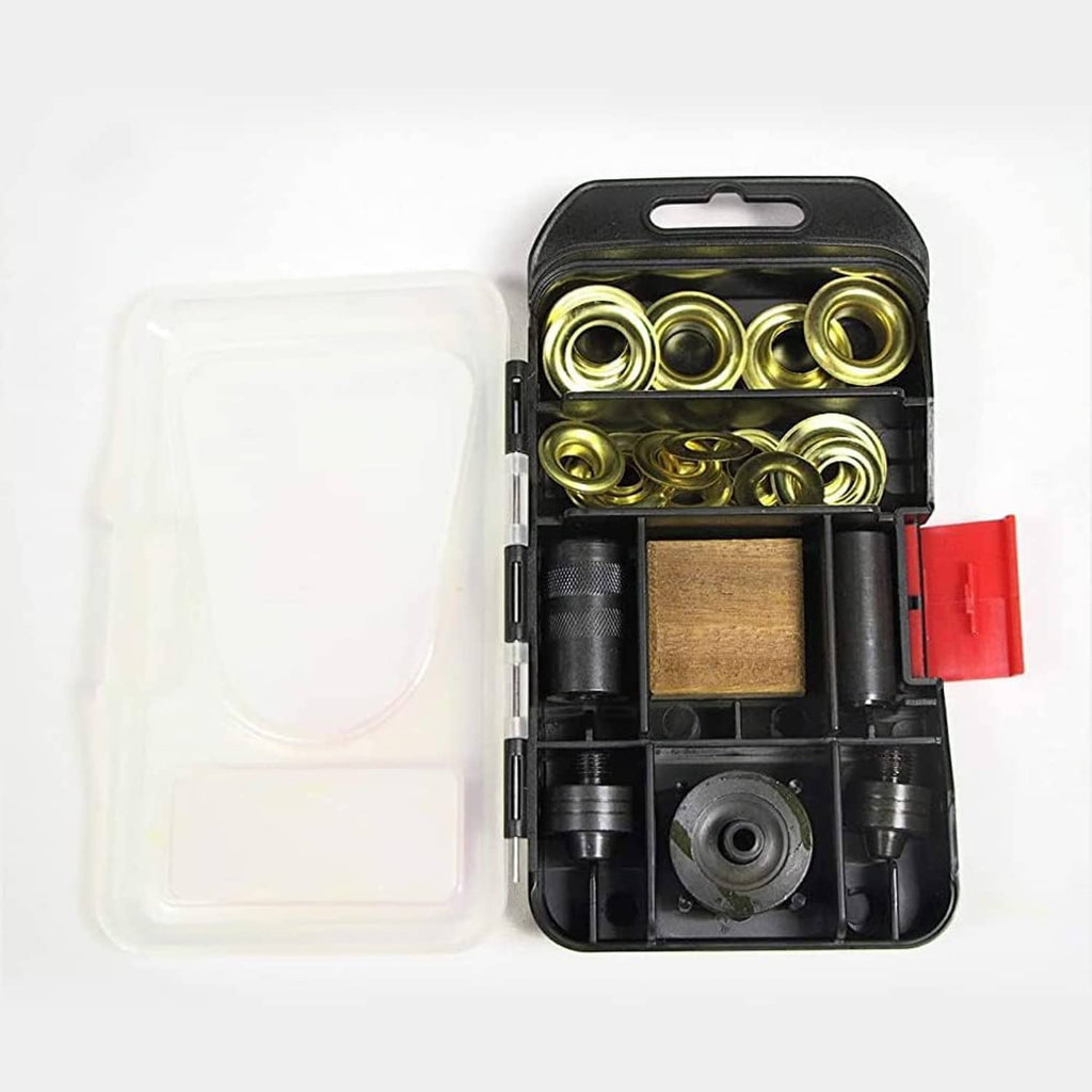 Opened grommet kit showing gold grommets, black dies, and wooden backing