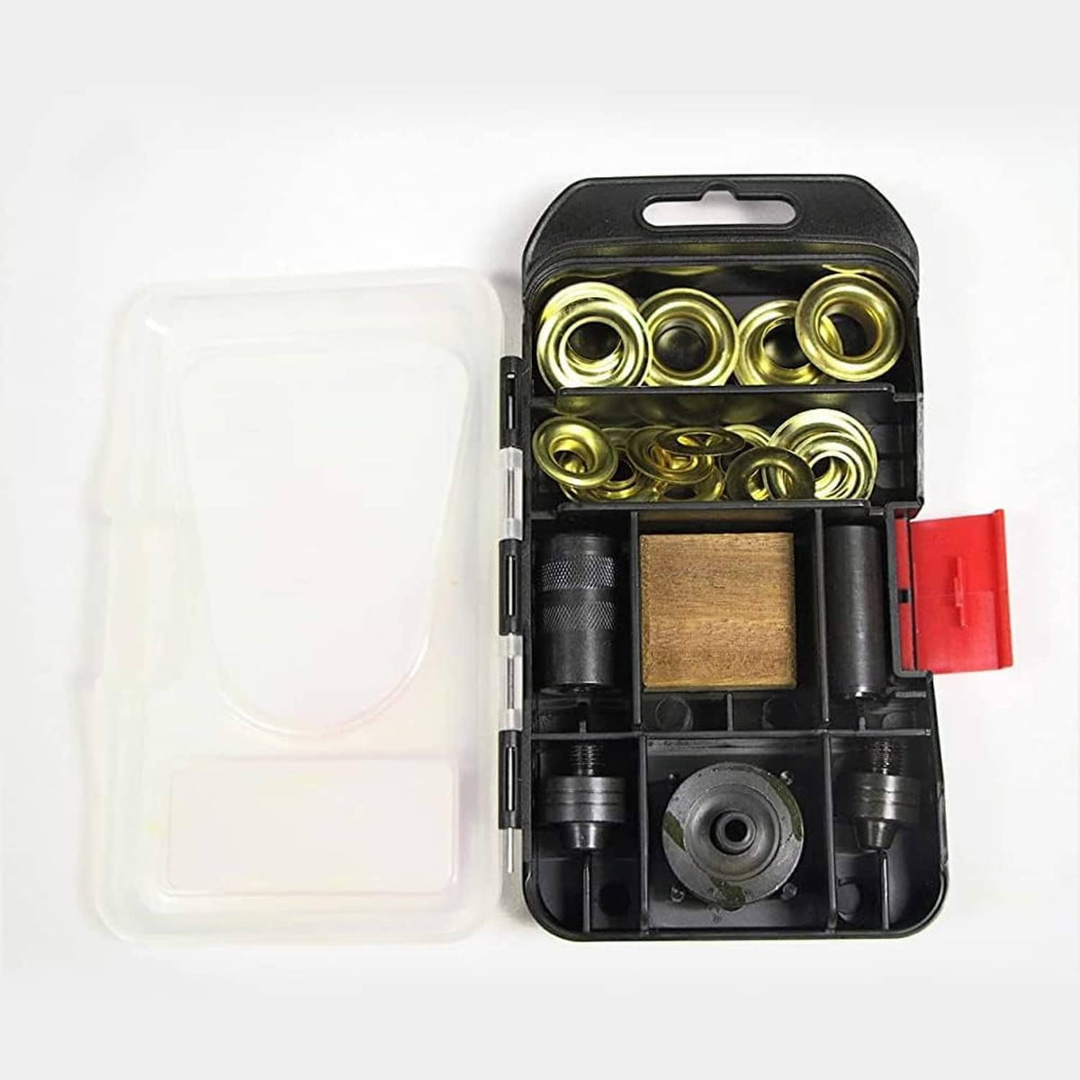Opened grommet kit showing gold grommets, black dies, and wooden backing