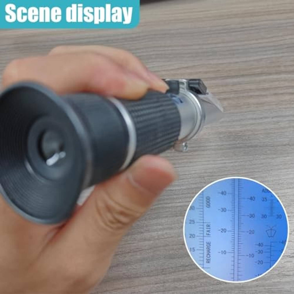 Hand holding antifreeze refractometer; blue viewing window with black eyepiece