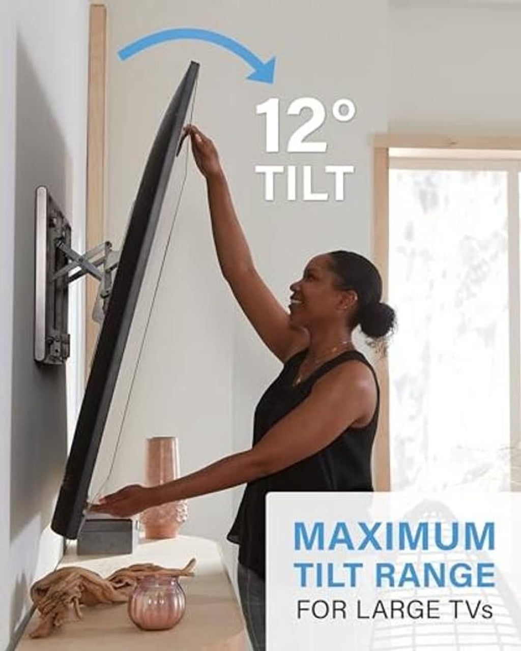 Black tilting TV wall mount mounted on wall with TV leaned outward on arms