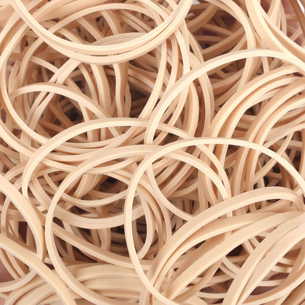 Beige elastic rubber bands macro view of overlapping loops and rings