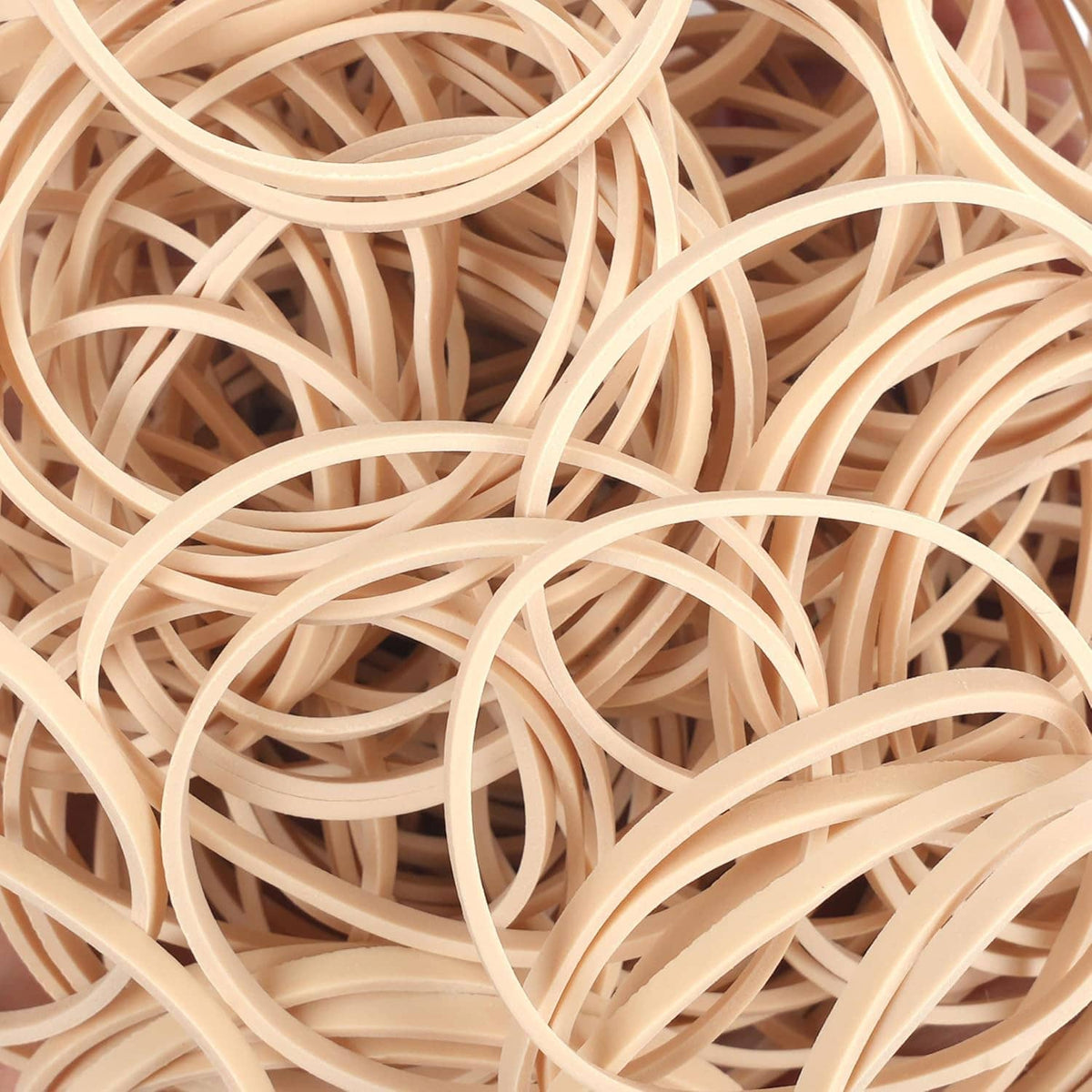 Beige elastic rubber bands macro view of overlapping loops and rings