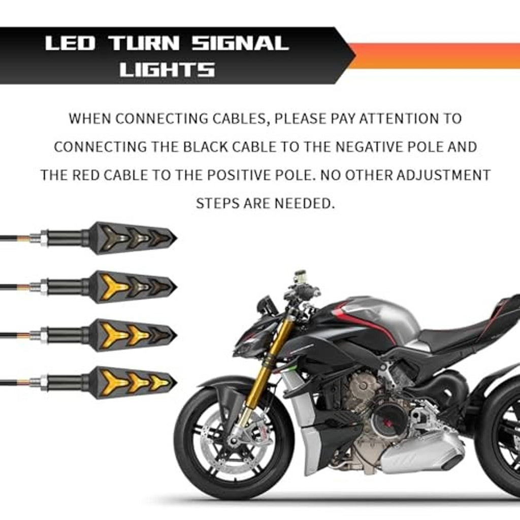 Four motorcycle LED turn signals with amber arrow LEDs on black housings and connector wires