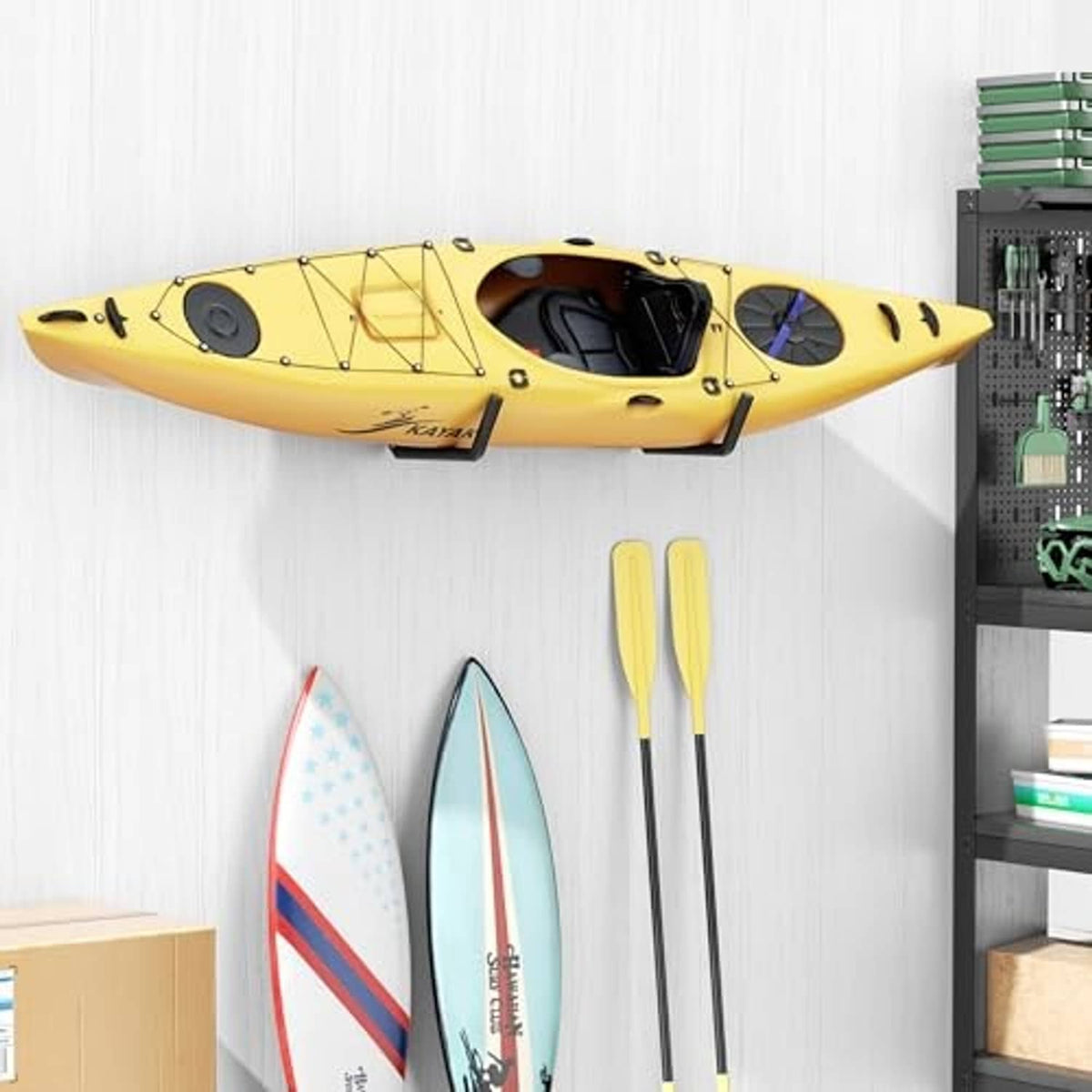 Black wall storage hooks supporting a yellow kayak with two surfboards nearby
