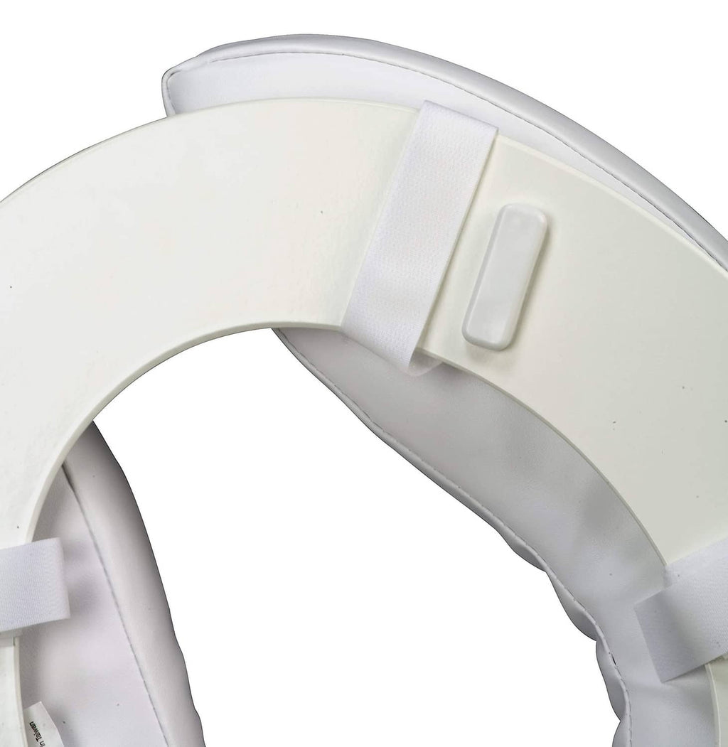 Close-up of toilet seat cushion straps securing around lid, white vinyl