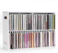 White wall-mounted CD rack with two rows of jewel case slots, holding assorted CDs