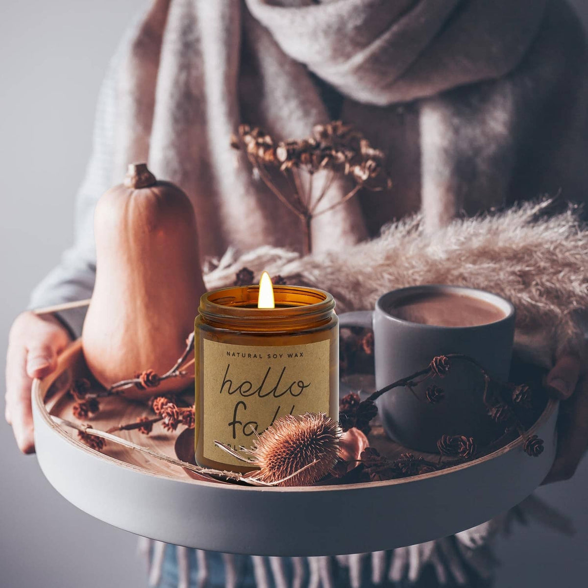 Hello Fall soy candle in amber jar with white wick on round tray