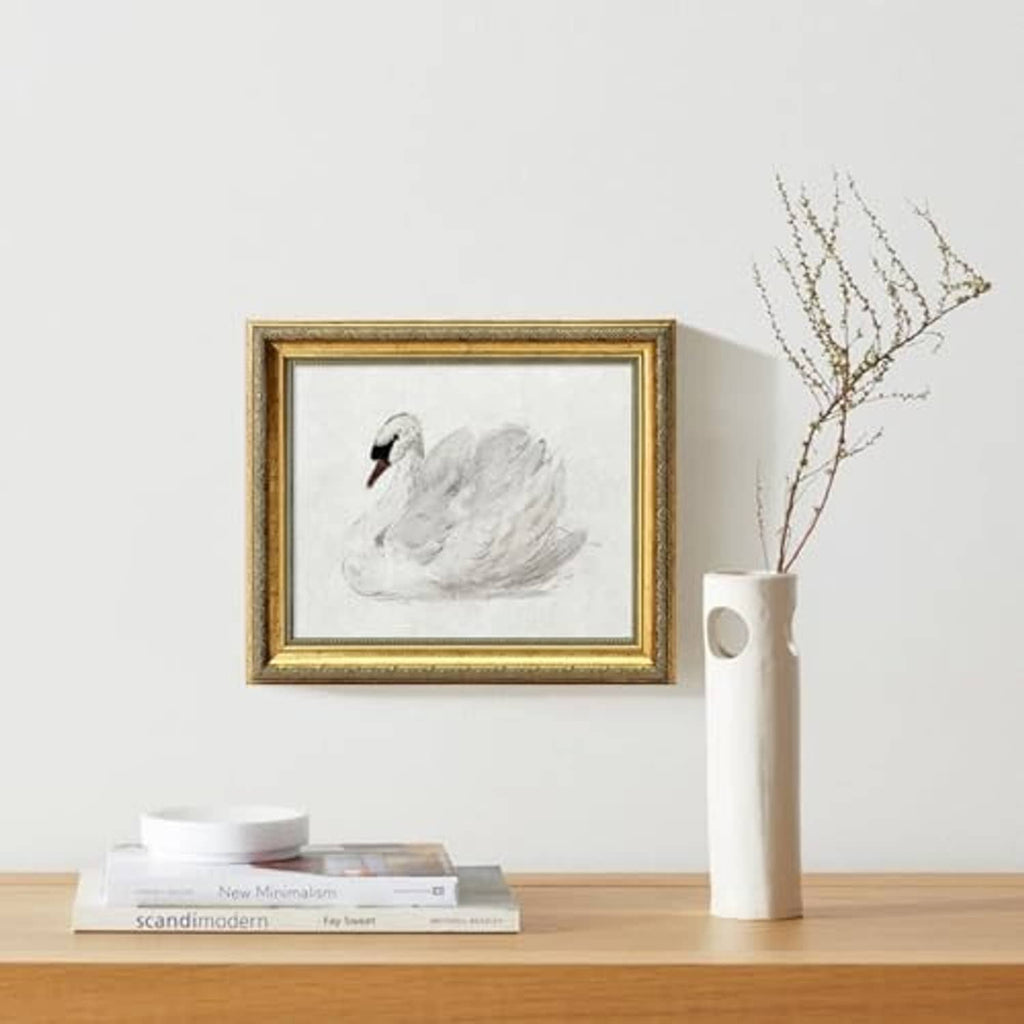 Ornate rectangular gold picture frame with clear glass, displaying a swan illustration print