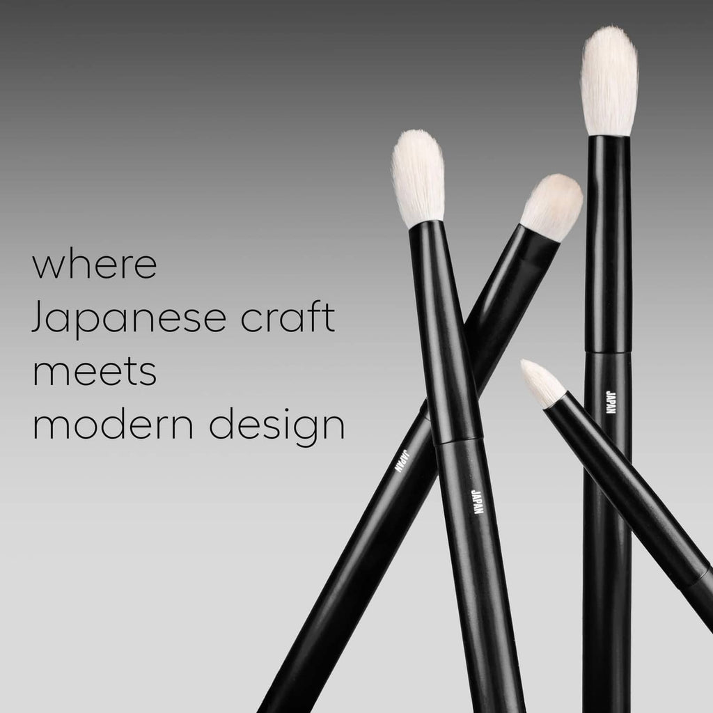 Four angled black eye makeup brushes with cream goat-hair bristles