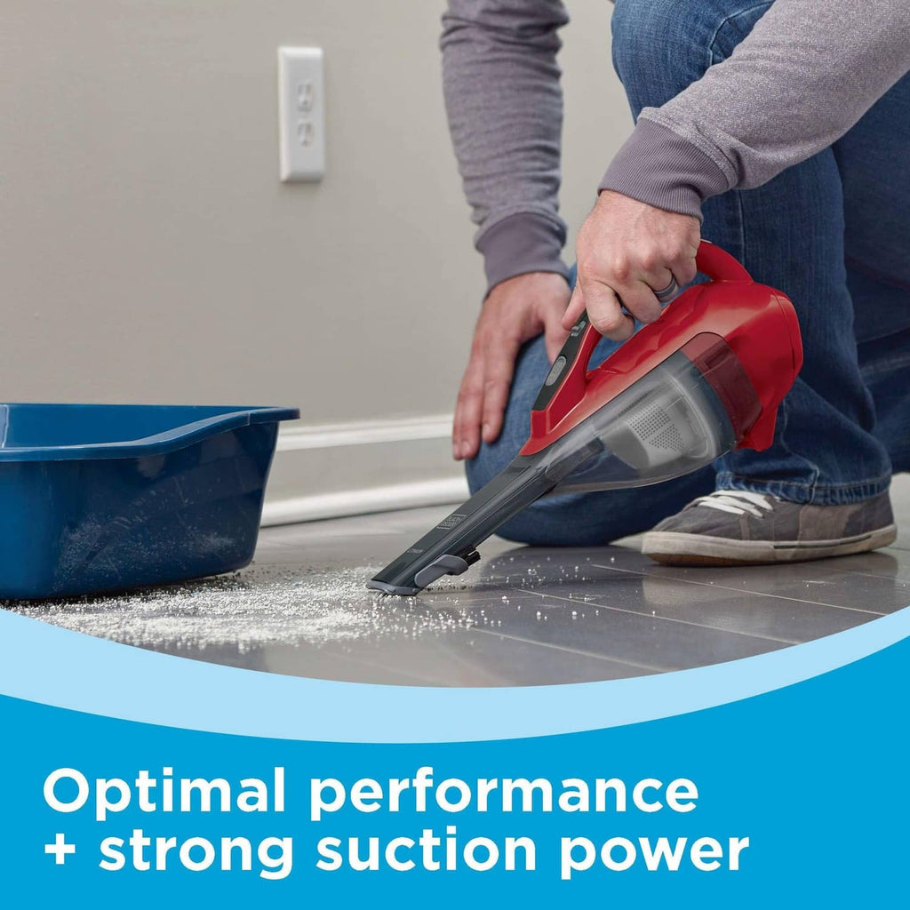 Cordless handheld vacuum in red and black cleaning a hard floor with narrow nozzle