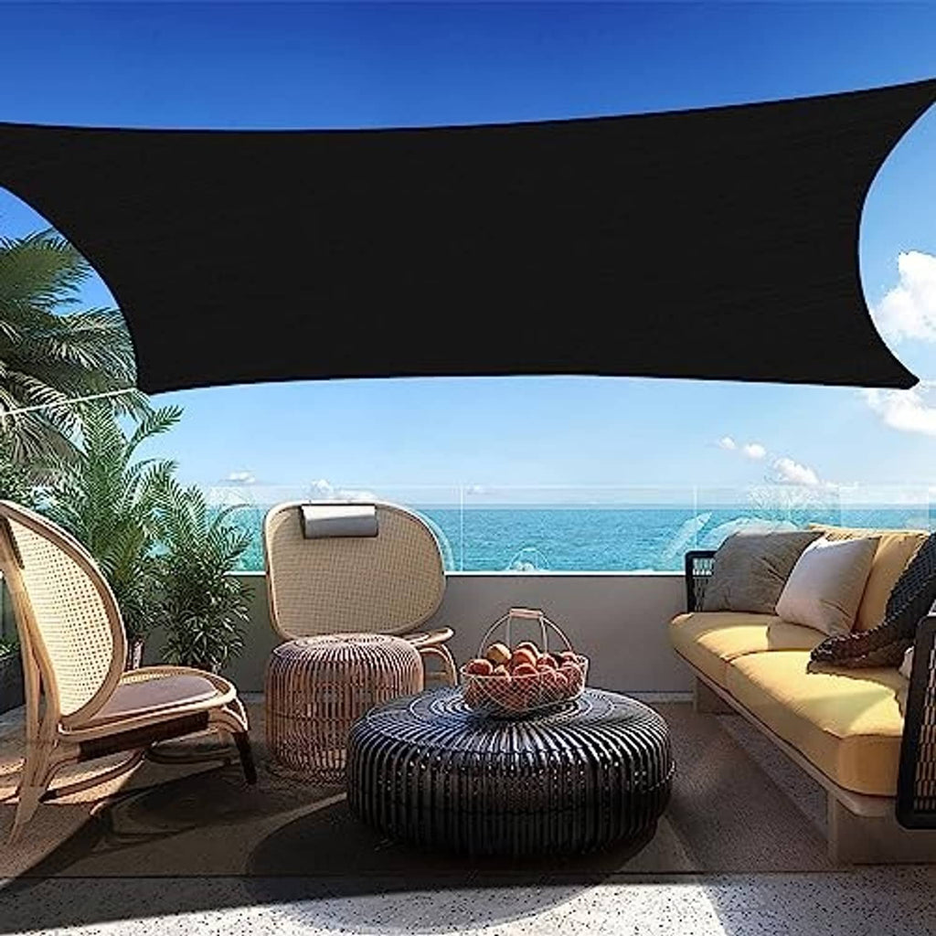 Black rectangle sun shade sail stretched above patio seating with curved edges