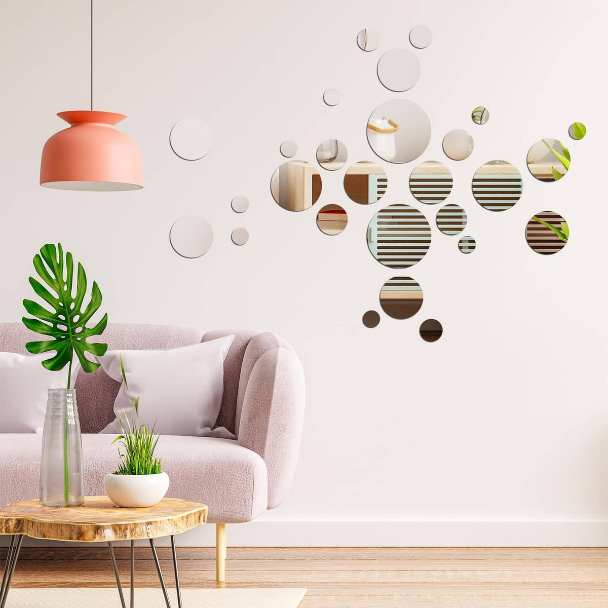 Silver circular acrylic mirror tiles and small mirror pieces arranged on a wall