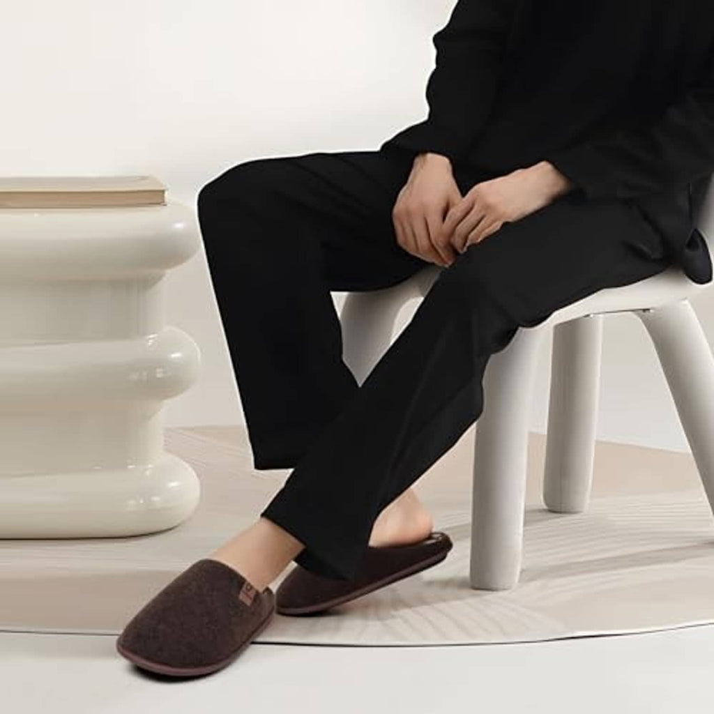 Cozy dark brown scuff slippers worn with dark pants, low slip-on style