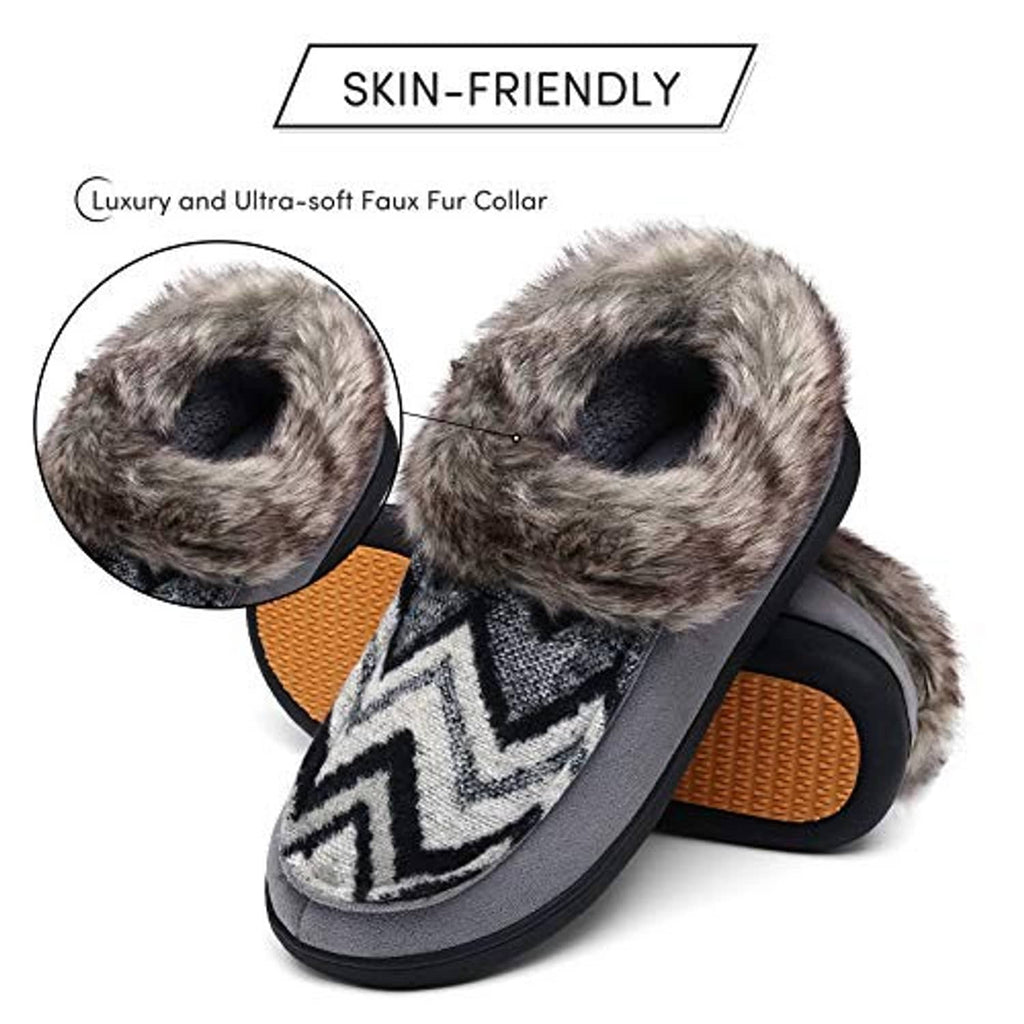 Grey moccasin slippers with faux-fur cuff and zigzag patch, orange grippy footbed visible.