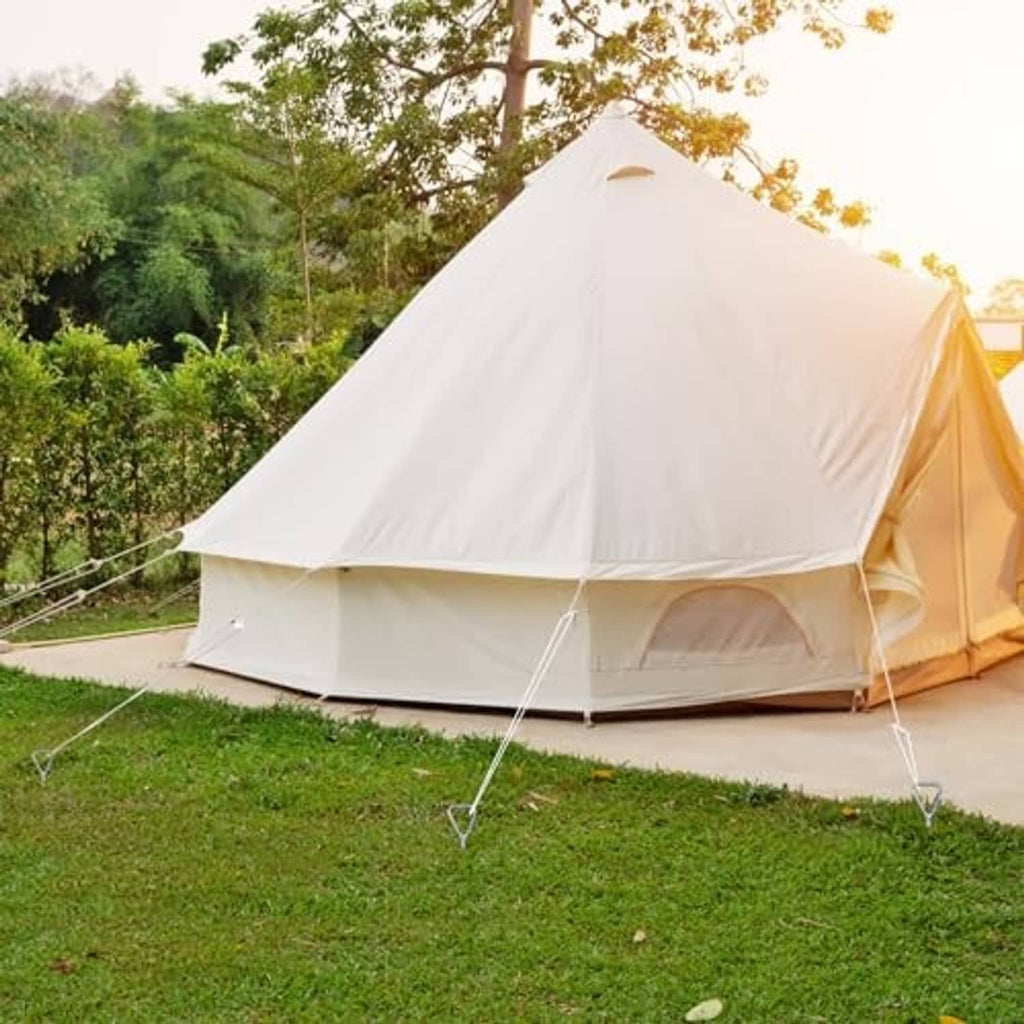 Chrome ground anchor stakes holding tent guy lines at corners of a white camping tent.