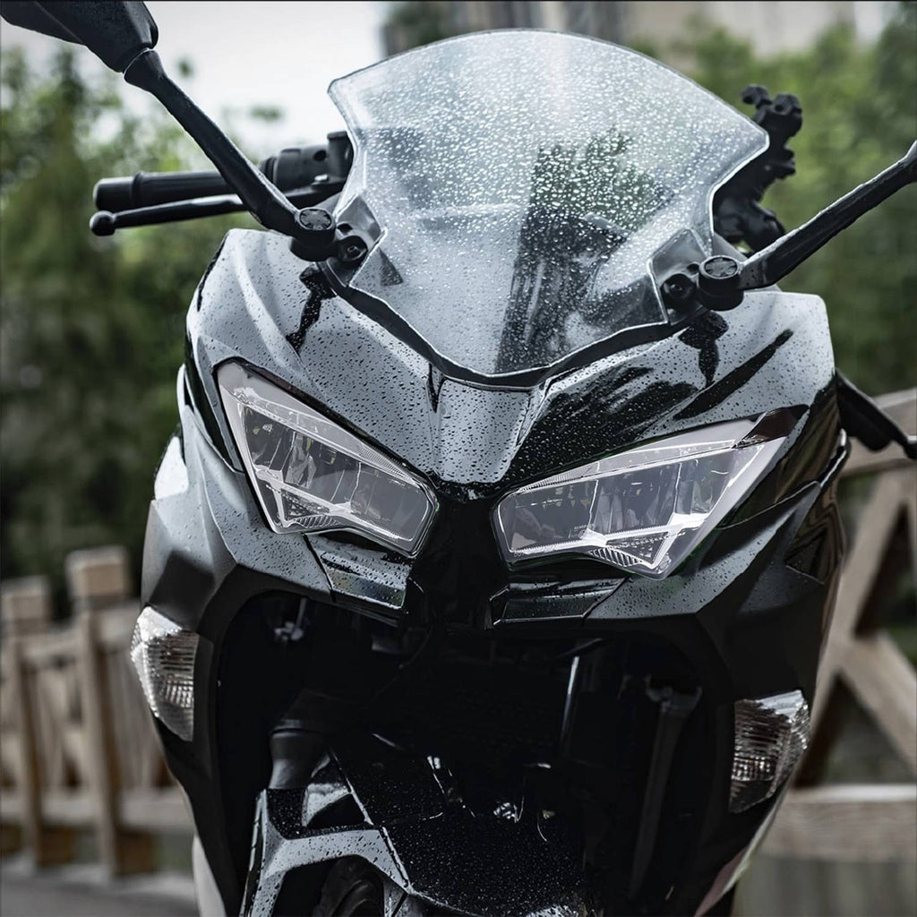 Motorcycle front headlight assembly with clear lenses and dark housing