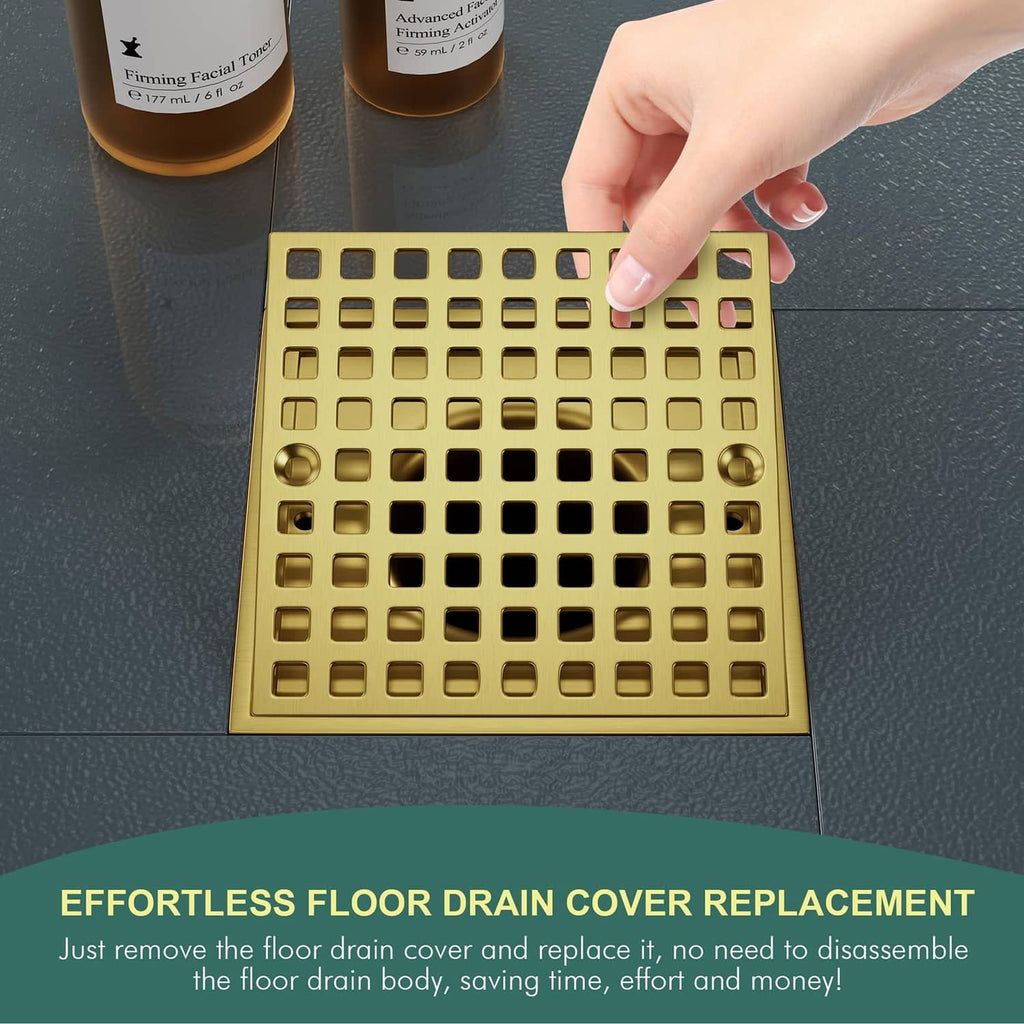 Gold square drain cover being placed by hand over a shower drain opening
