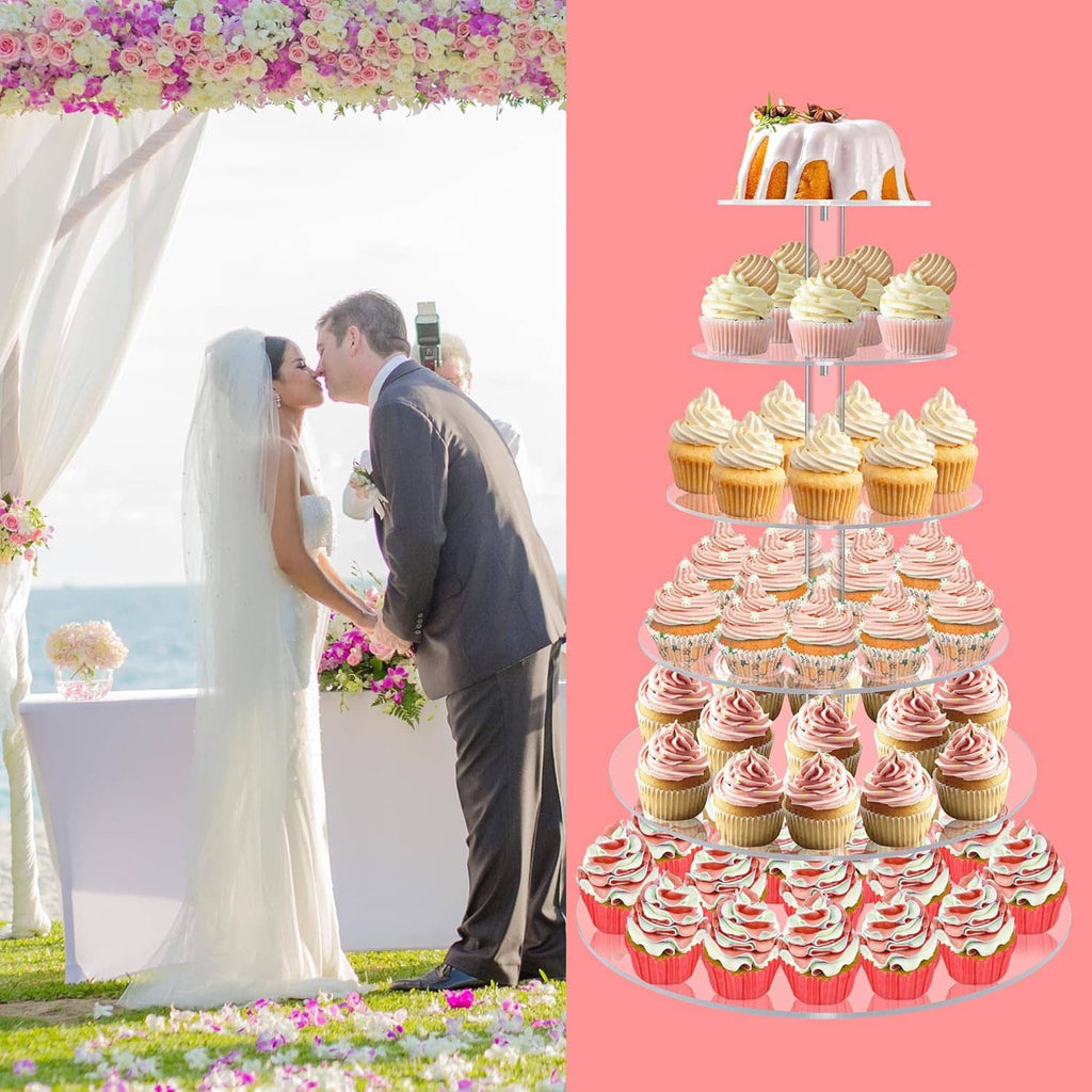 Tiered acrylic cupcake stand with pink swirled cupcakes and decorative toppers