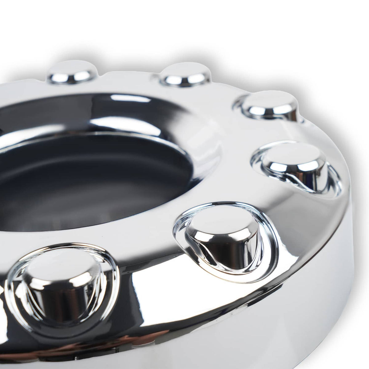 Close-up of chrome wheel center hub cap with raised ring and bolt holes