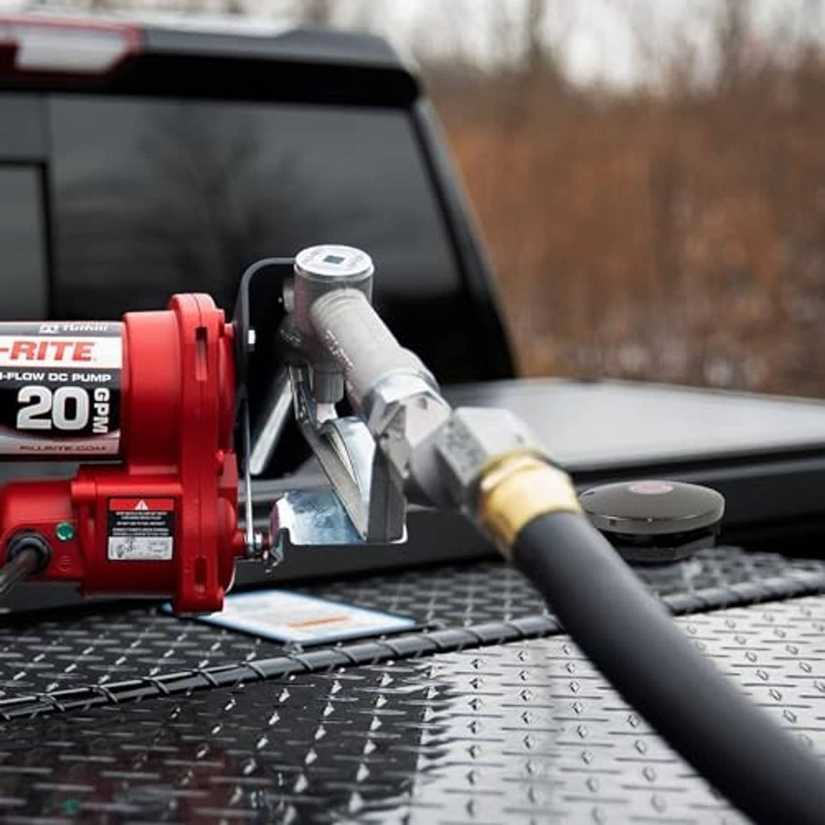 Installed vented fuel transfer cap on pickup truck bed, threaded outlet