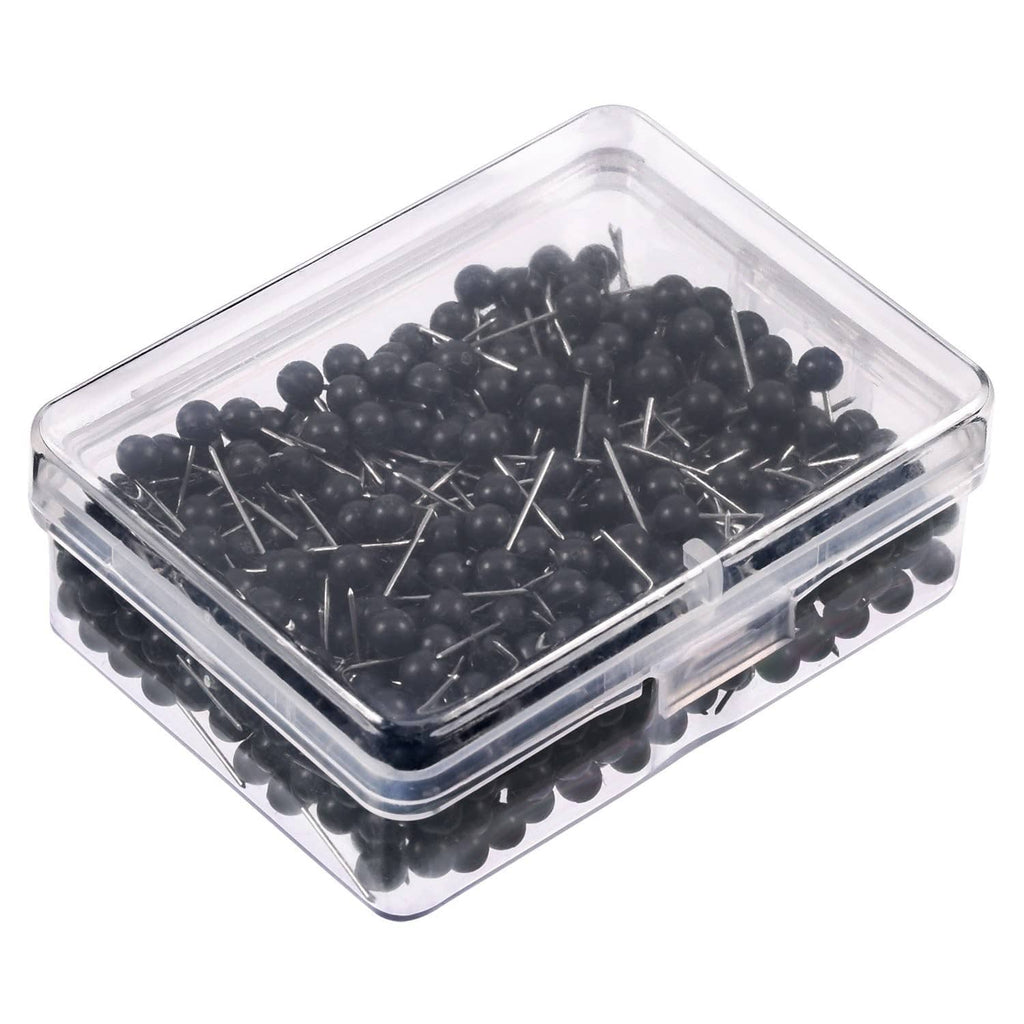Black push pins with round heads and metal tips in a clear square organizer box.
