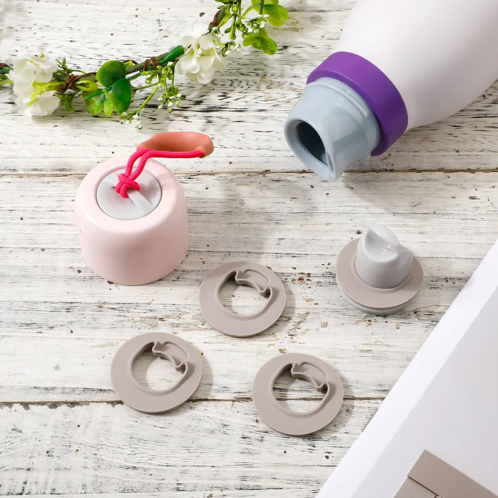 Set of gray water bottle stoppers with pink bottle; purple cap detail and stopper pieces