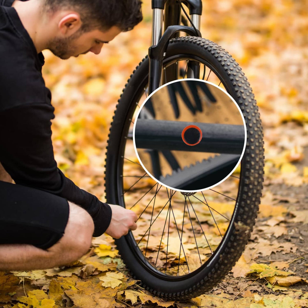 Bicycle tire close-up with round black rubber patch highlighted on the rim area