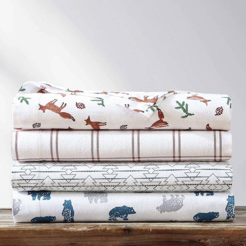 Queen sheet set stack with white flannel sheets, blue animal print and brown plaid stripe