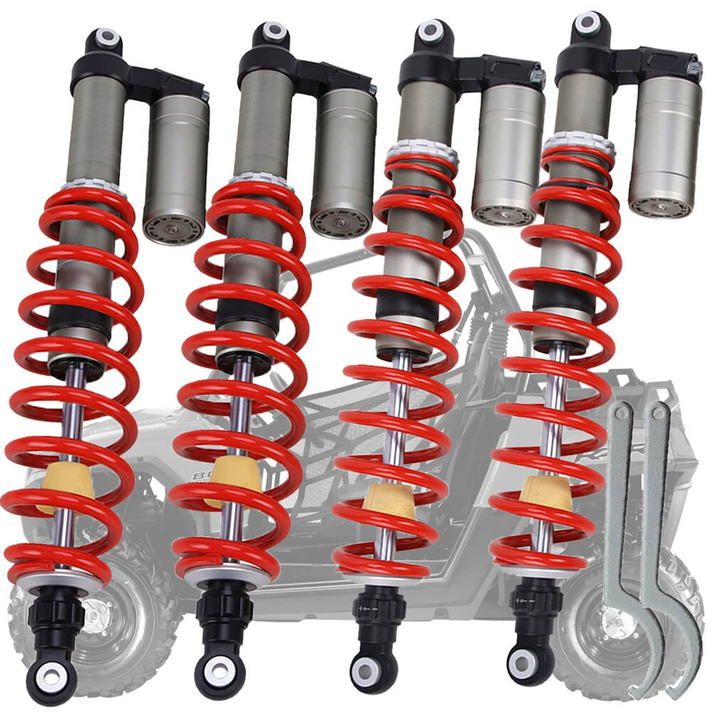 Close view of four shock absorbers with red coil springs and black top mounts
