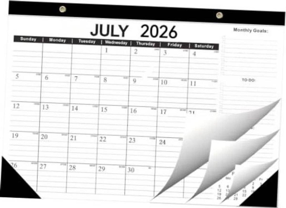 July 2026 desk calendar sheet with black header and monthly grid, corner guards