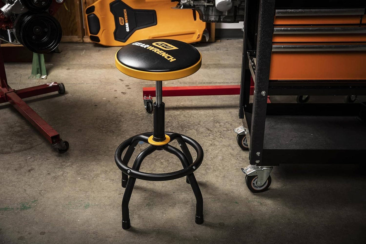 GEARWRENCH shop stool with black seat and orange edge, black swivel base and stem
