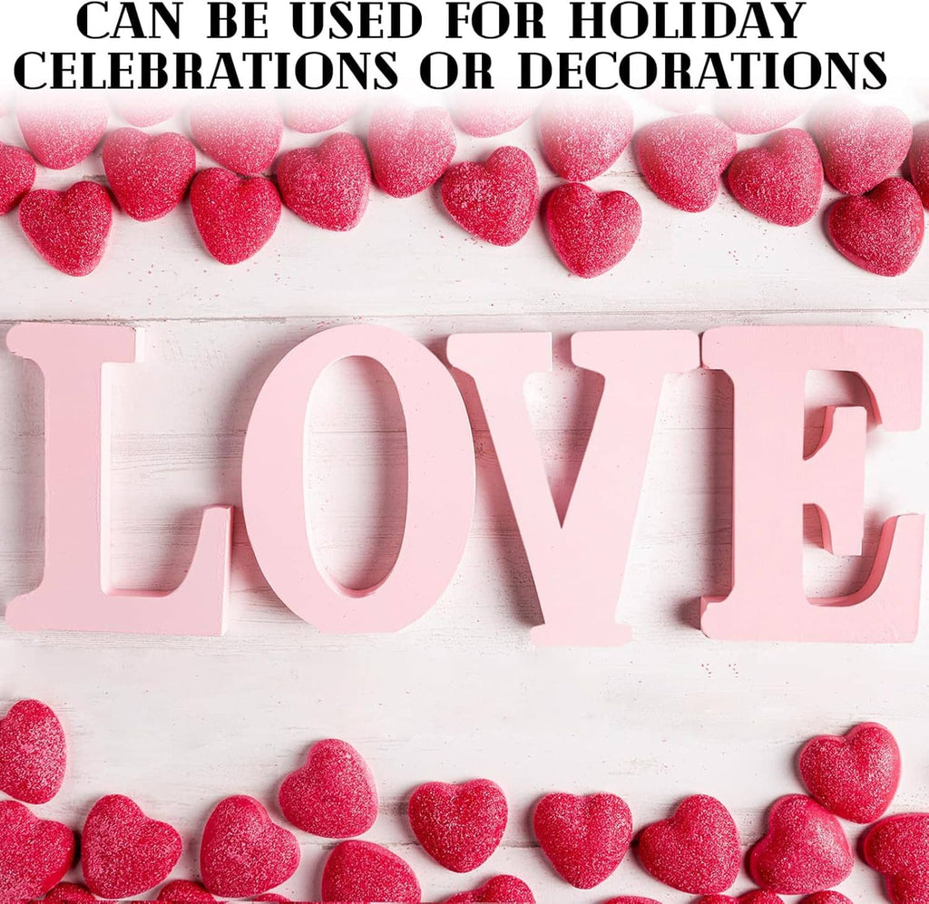 White unfinished wooden letters spelling LOVE with heart-shaped accents
