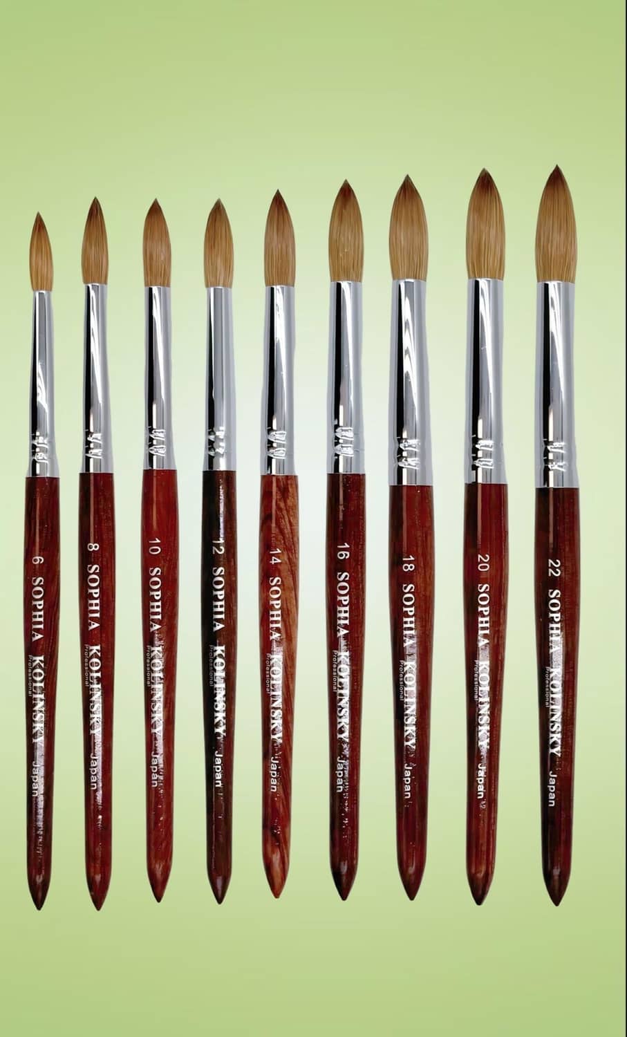 Round nail brush with brown bristles and red wooden handle, multiple sizes shown