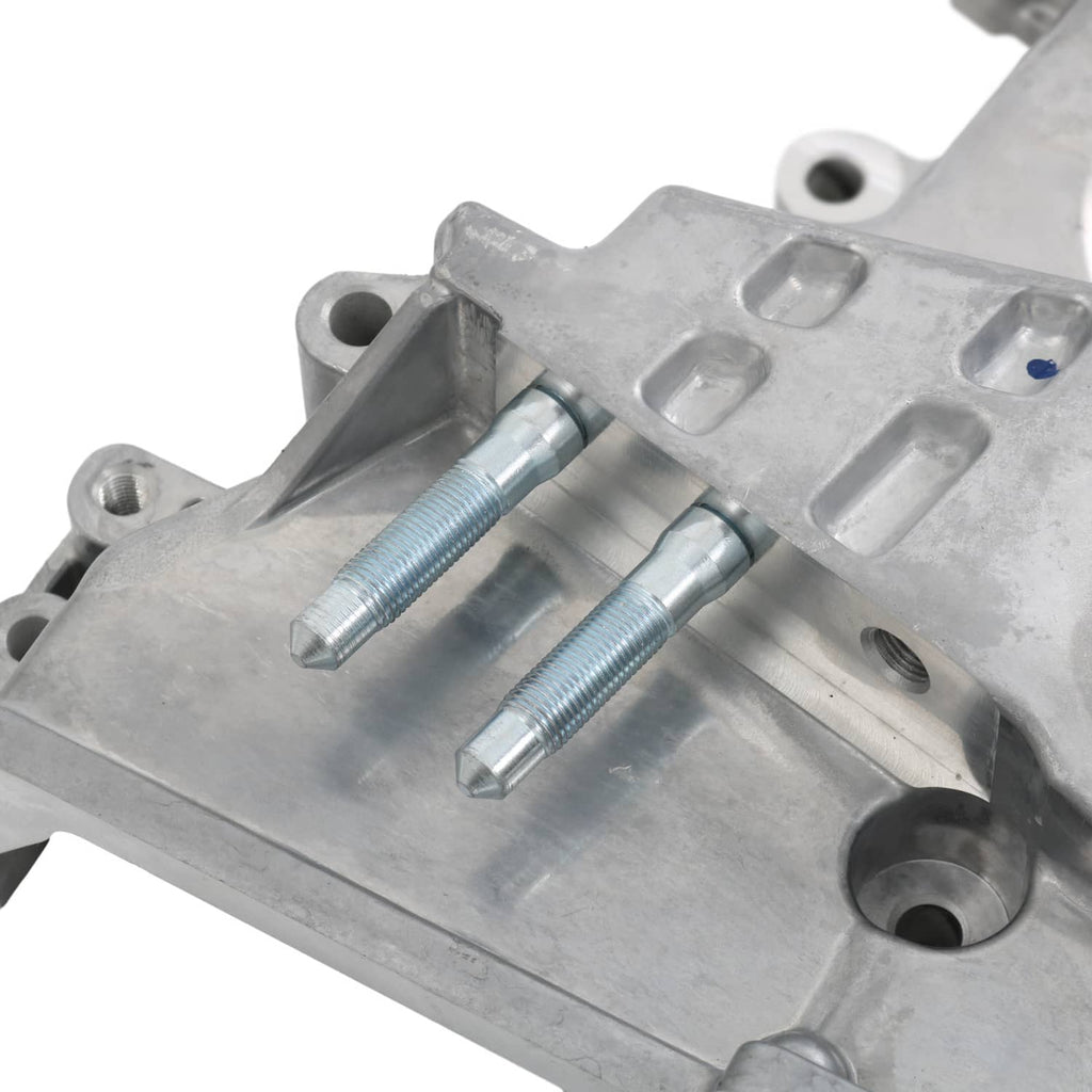 Timing cover oil pump housing close-up with two threaded bolts and silver metal channels
