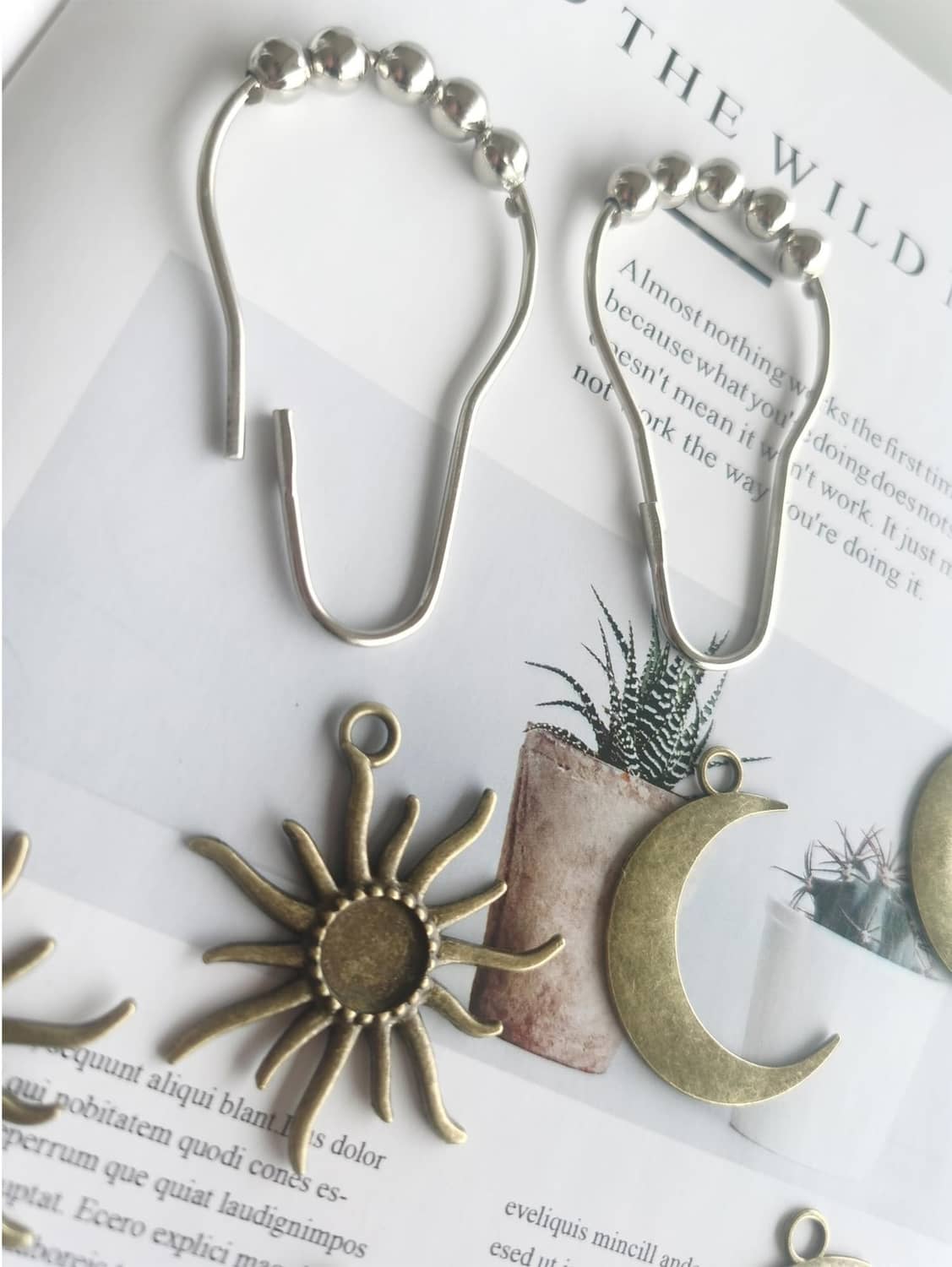 Set of metal shower curtain hooks with beaded tops and sun and moon charm pieces