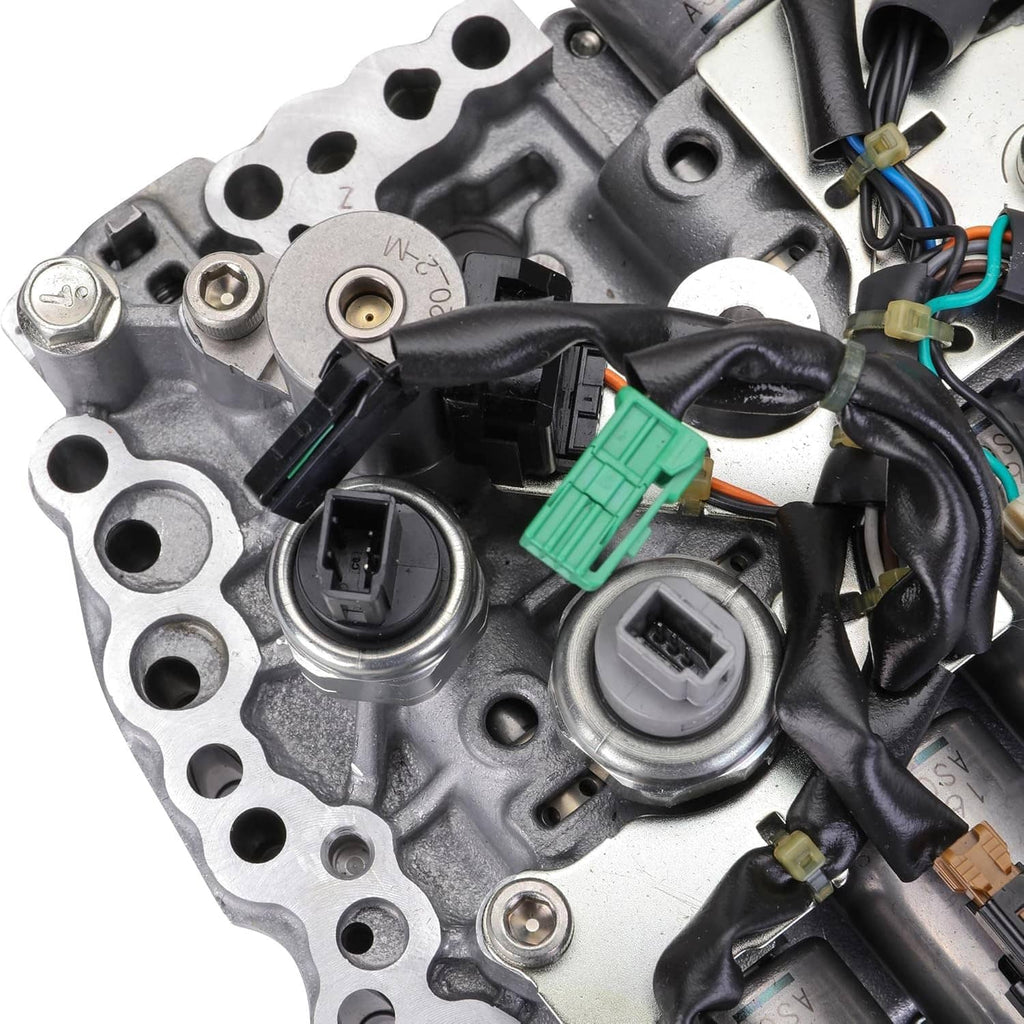 CVT transmission valve body with solenoids, close-up of solenoid caps and wiring plugs