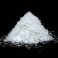 White fiberglass reinforcement strands, loose pile of 3/4 in pieces