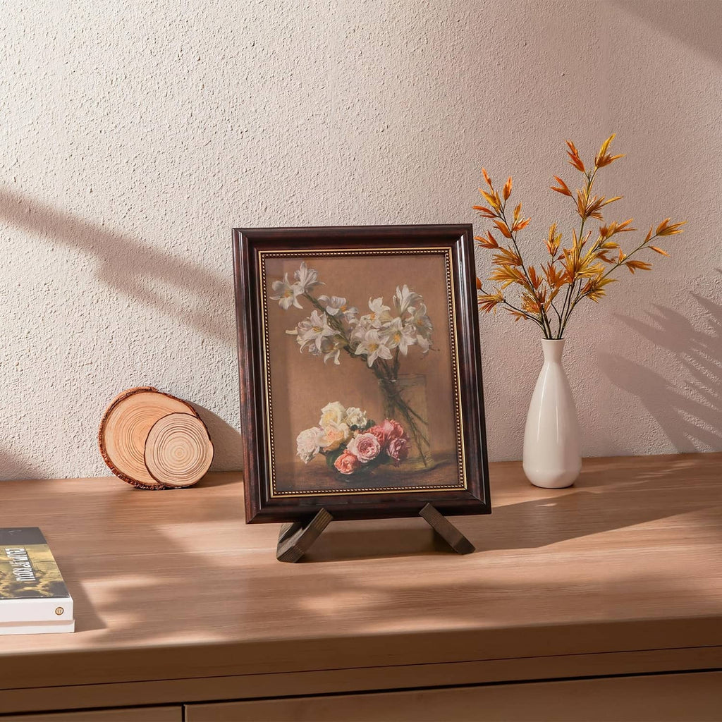 Brown plate stand holding a small framed artwork on tabletop display