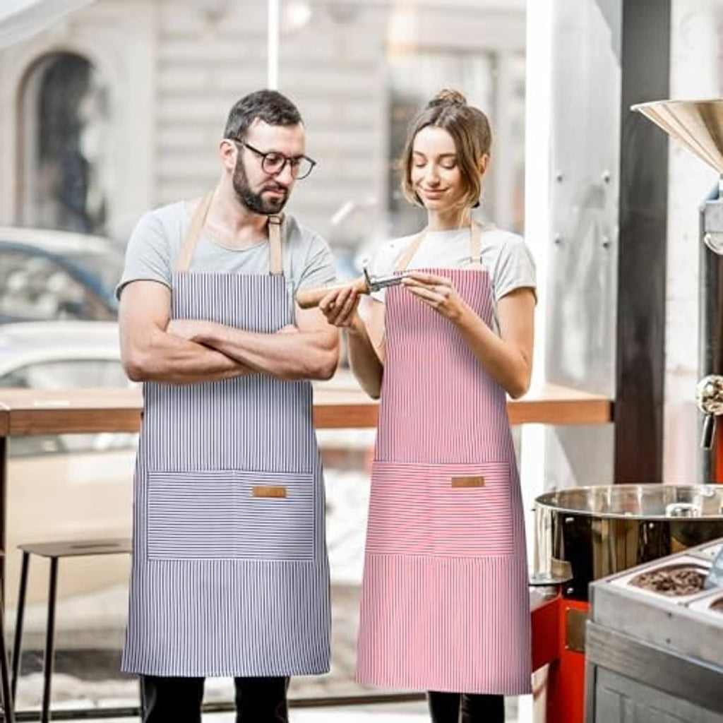 Two adjustable bib aprons in blue and pink pinstripes, each with front pocket