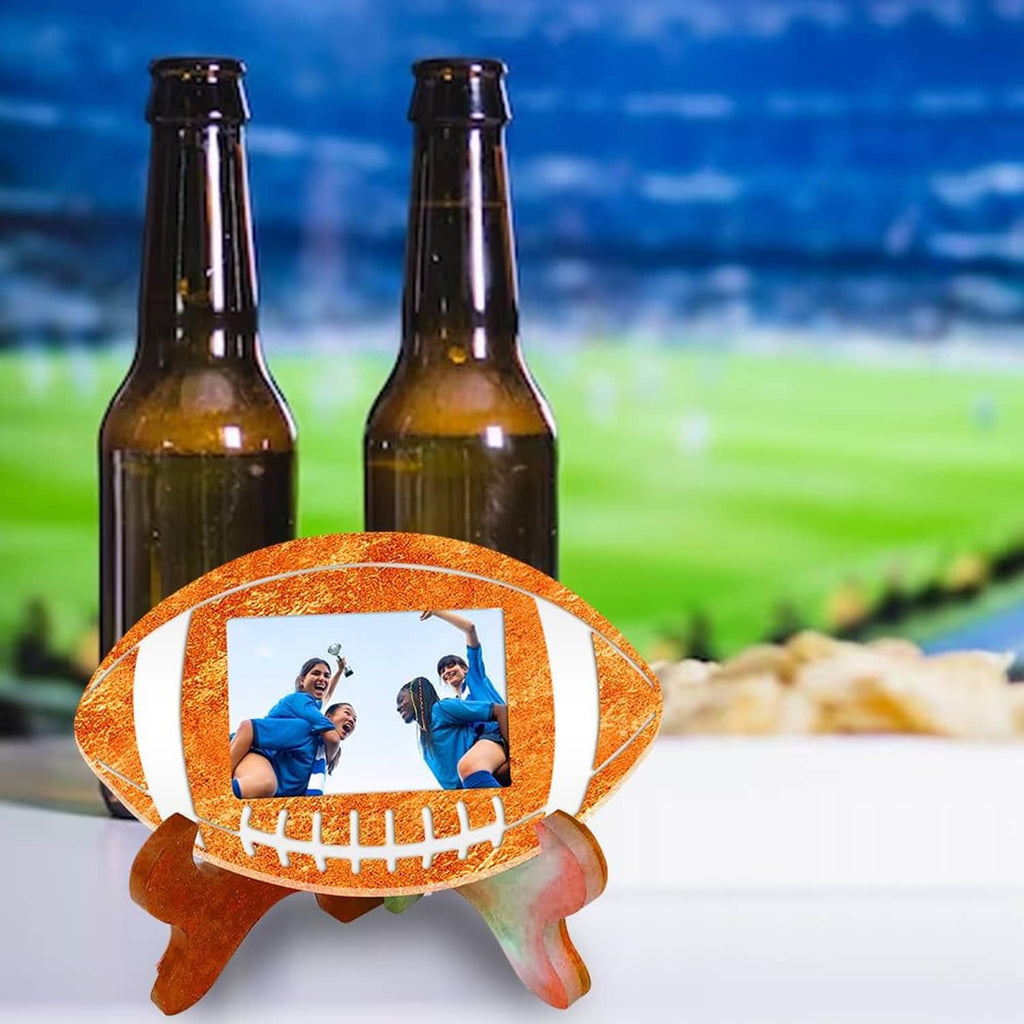 Football photo frame ornament on table with photo window and orange-brown stand