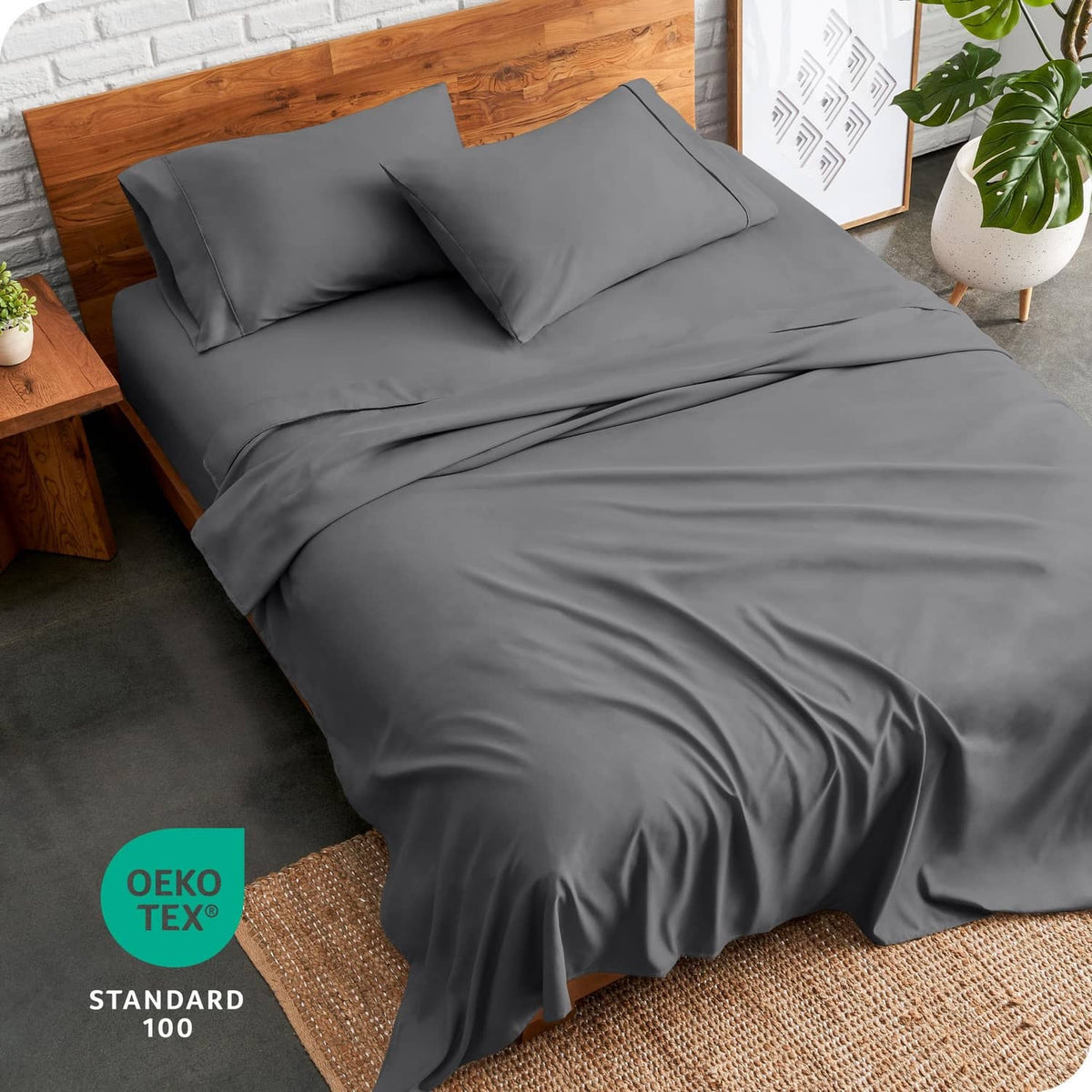 Grey split queen bedding set with pillowcases and fitted sheet on bed