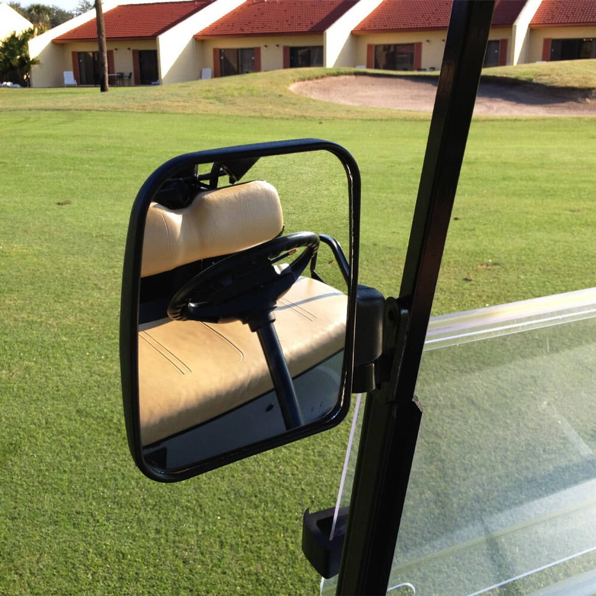Golf cart side mirror attached to frame with black housing and convex glass