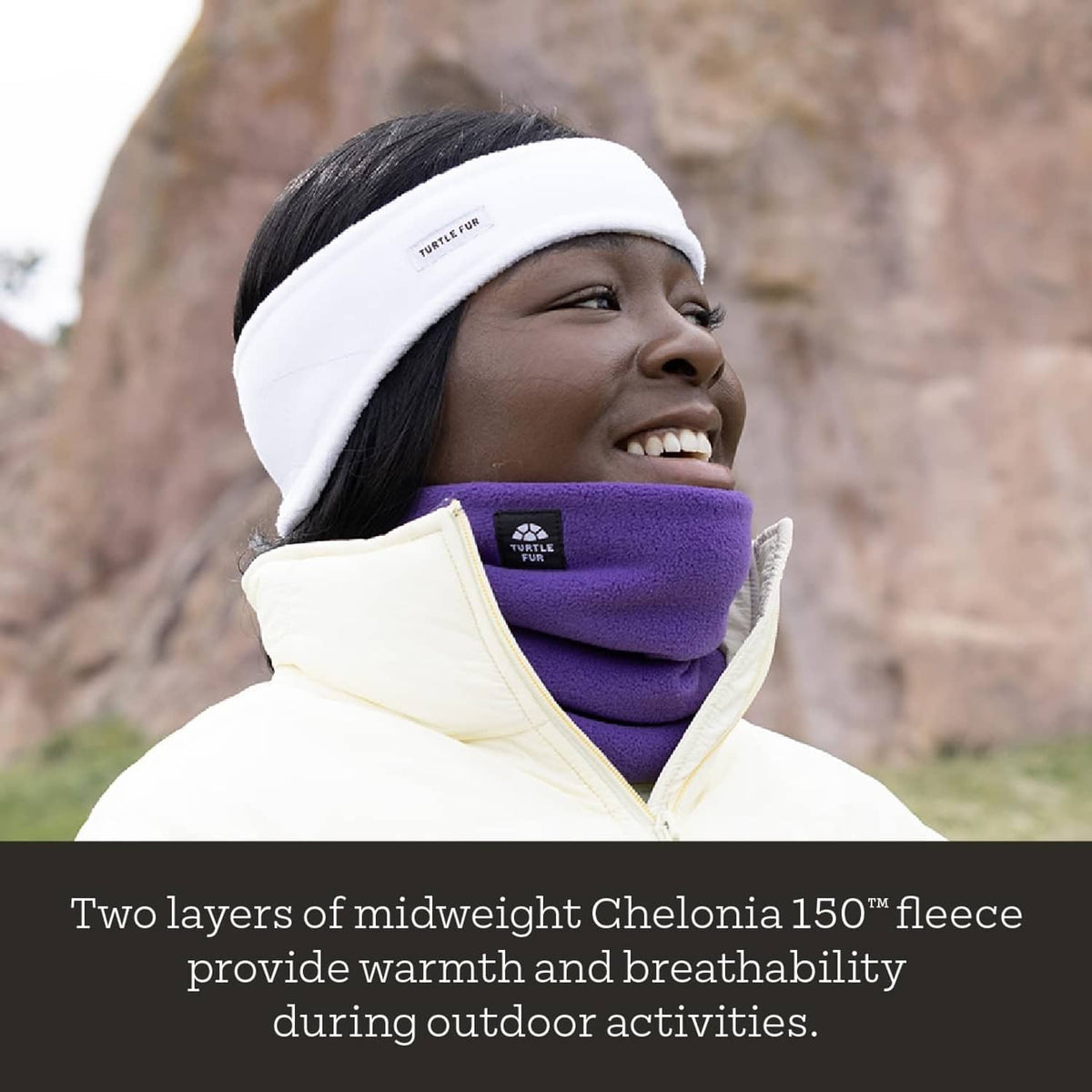 Fleece neck warmer, purple with black trim and white top band, worn under jacket
