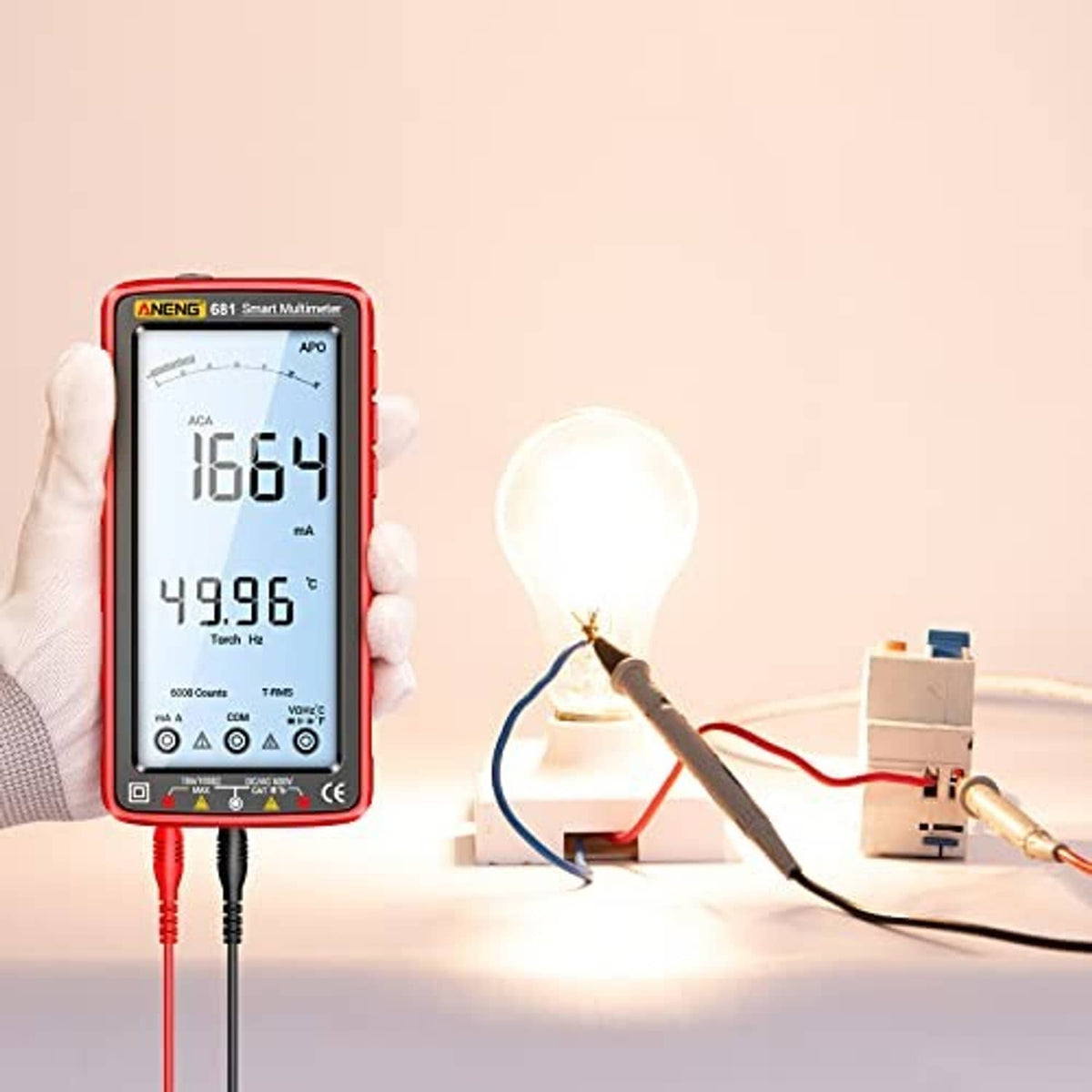 Red digital multimeter tester with backlit LCD display and two wired test probes